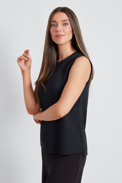 Woman wearing the Butter sleeveless shell top in Black, side view.