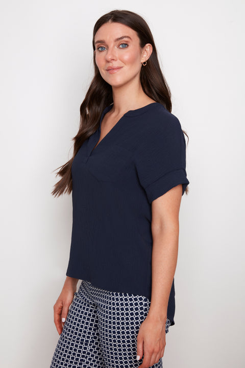 Side view of model wearing UP! Air Flow Short Sleeve Top in Navy.