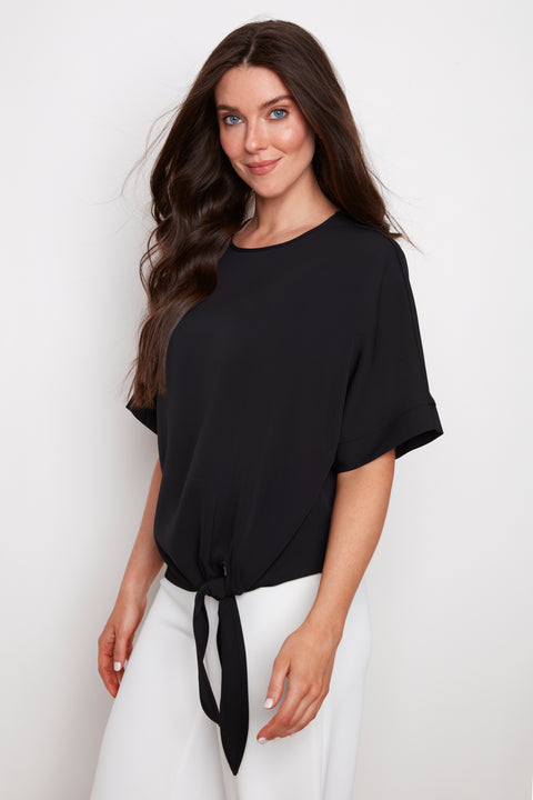 Side view of model wearing UP! Vegan Silk Tie Knot T-Shirt in Black with front tie-knot detail.