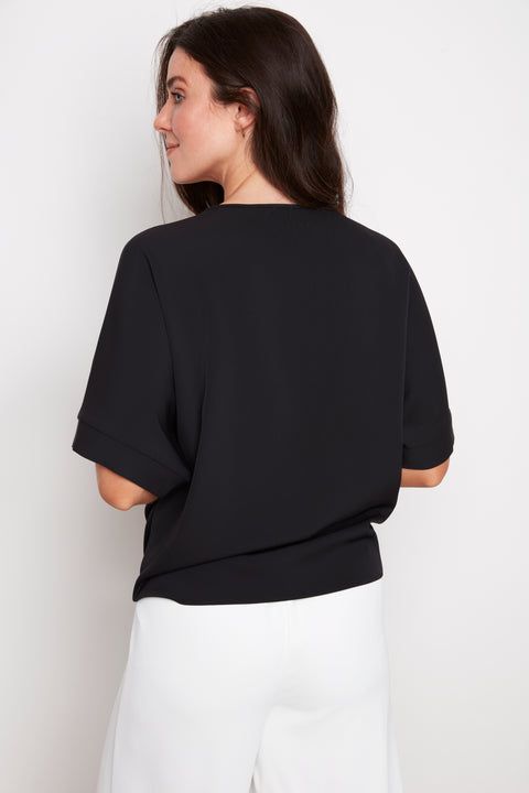 Back view of model wearing UP! Vegan Silk Tie Knot T-Shirt in Black.