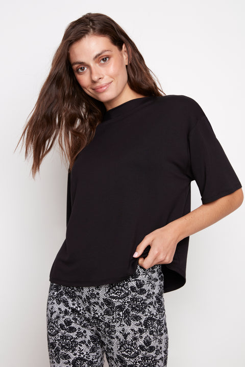Model wearing UP! Provence Short Sleeve Top in Black, front view.