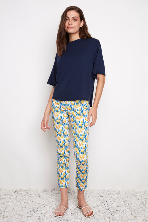 Model wearing UP! Lemon Blossom Techno Petal-Slit Ankle Pant featuring a slim fit and petal vent hem.
