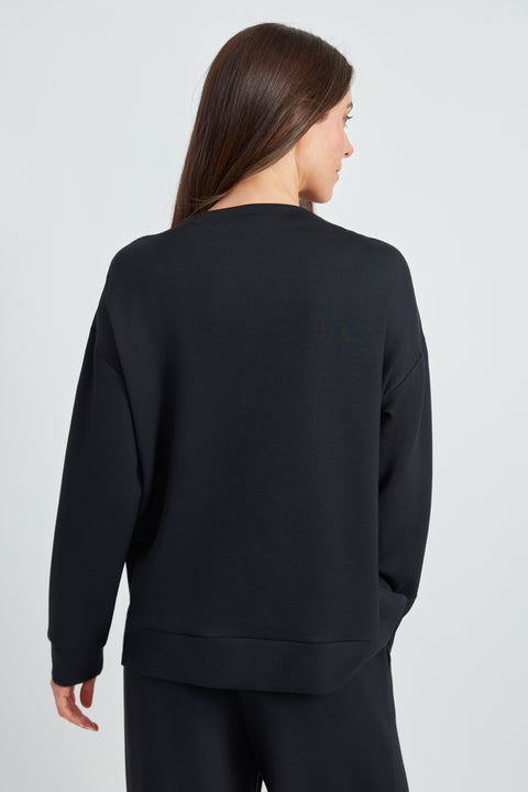 Backview of the Butter 3-Button Top in Black with gold button shoulder detail.