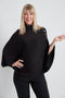 Woman wearing the Butter Cape in Black.