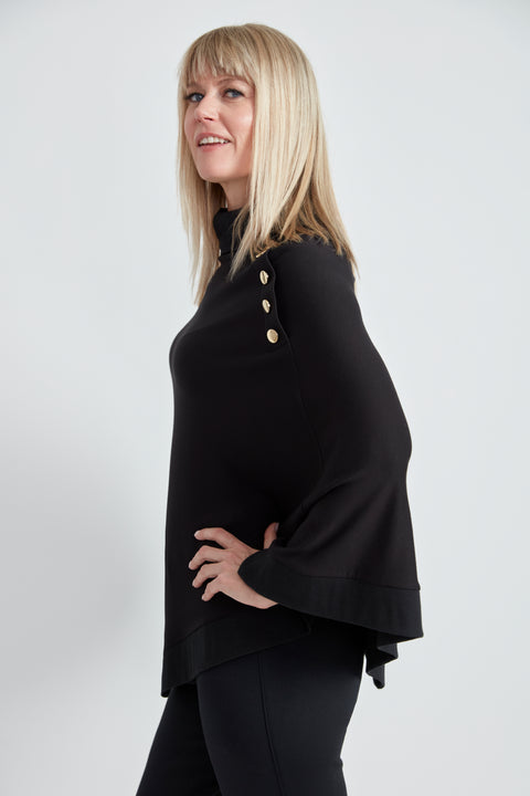 Woman wearing the Butter Cape in Black, side view.