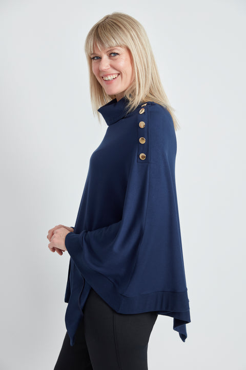 Woman wearing the Butter Cape in Harbor Blue, side view.