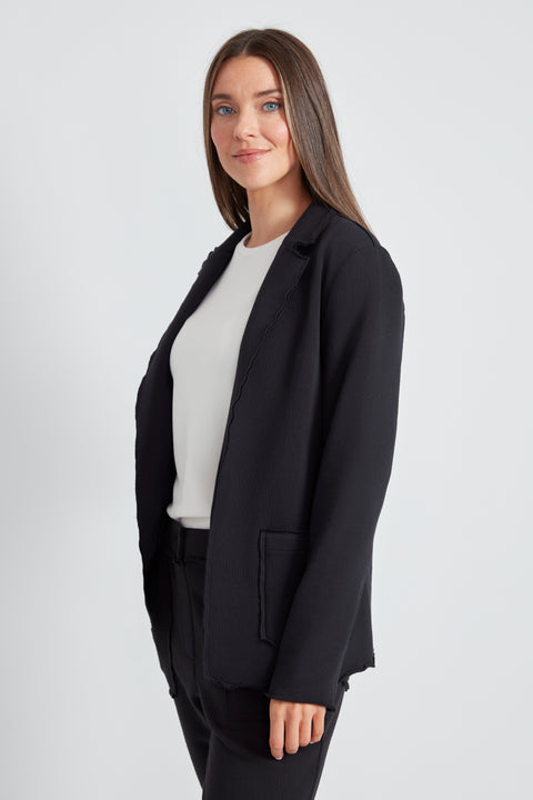Woman wearing the French Terry Raw Edge Blazer in Black, side view.
