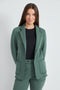 Woman wearing the French Terry Raw Edge Blazer in Ivy Green.