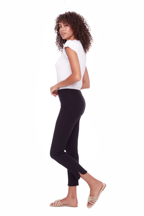 Side view of model wearing UP! Techno Core Petal-Slit Ankle Pant in Black with petal vent detail.