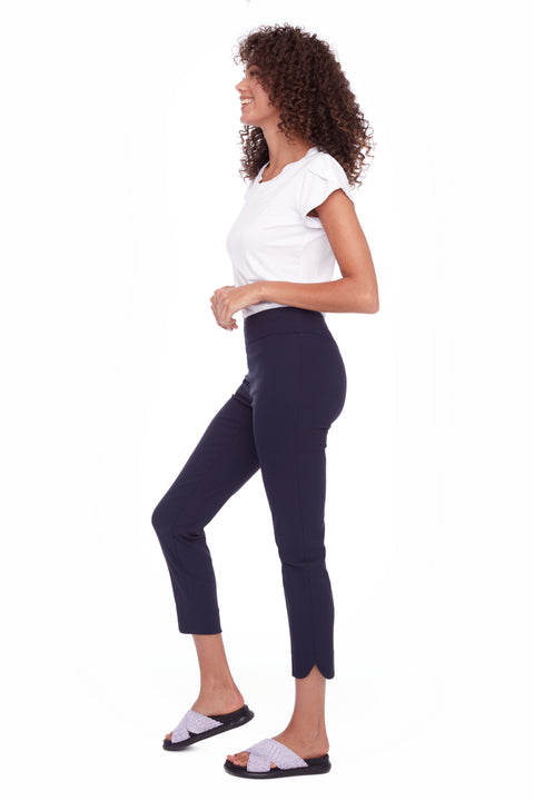 Side view of model wearing UP! Techno Core Petal-Slit Ankle Pant in Navy with petal vent detail.