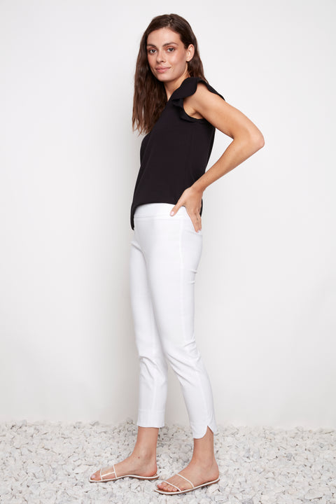 Side view of model wearing UP! Techno Core Petal-Slit Ankle Pant in White with petal vent detail.