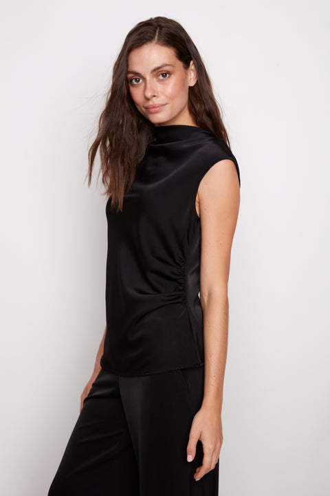 Side view of model wearing UP! Belize Satin Drapey Sleeveless Top in Black with high neckline and draped silhouette detail.