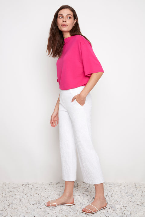 Side view of model wearing UP! Textured Techno Wide Leg Crop Pant in White Loom with angled pocket detail.