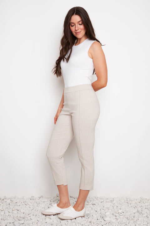 Side view of model wearing UP! Linen Effect Techno Cropped Front-Cuff Pant in Linen with front-cuff detail.