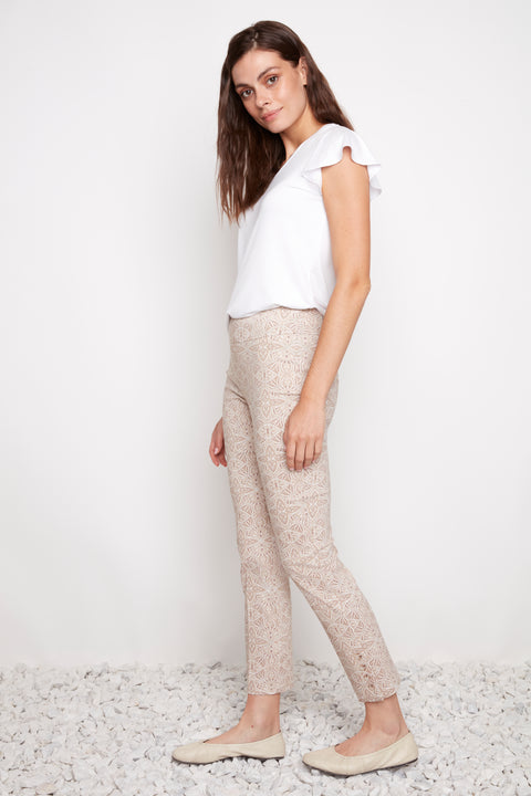Side view of model wearing UP! Gypsy Techno Button-Vent Ankle Pant in Gypsy print with button vent detail.