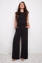 Model wearing UP! Vegan Silk Wide-Leg Full-Length Pant in Black, front view.