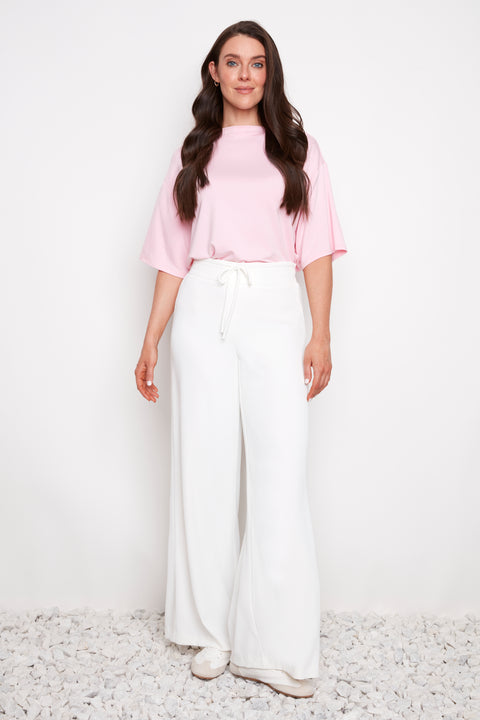 Model wearing UP! Vegan Silk Wide-Leg Full-Length Pant in Cream, front view.