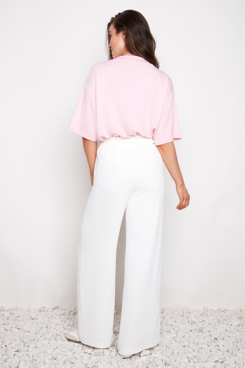 Back view of model wearing UP! Vegan Silk Wide-Leg Full-Length Pant in White.