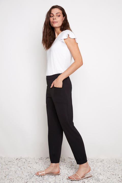 Side view of model wearing UP! Vegan Silk Jogger in Black with utilitarian-style side pocket detail.