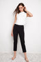 Model wearing UP! Compression Slim Front-Cuff Crop Pant in Black, front view.