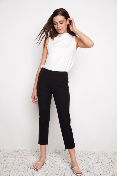 Model wearing UP! Compression Slim Front-Cuff Crop Pant in Black, front view.