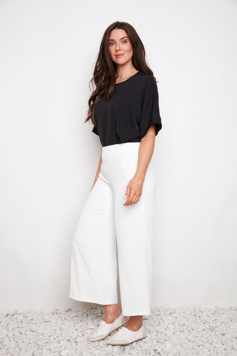 Side view of model wearing UP! Vegan Silk Wide Leg Cropped Pant in Cream
