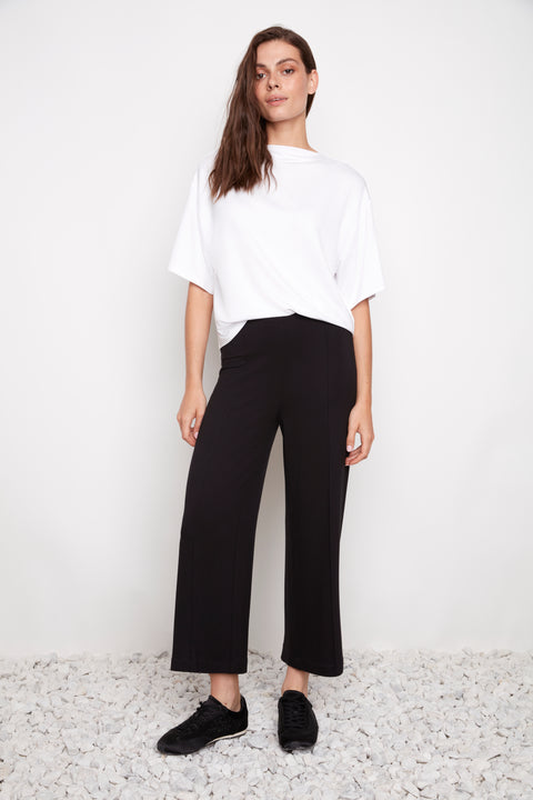 Model wearing UP! Provence Wide Leg Pintuck Crop Pant in Black, front view.