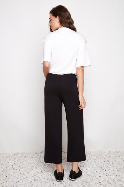 Back view of model wearing UP! Provence Wide Leg Pintuck Crop Pant in Black.