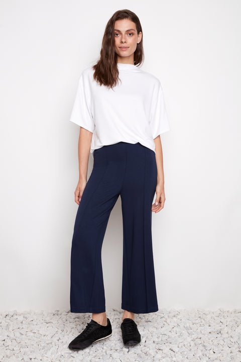 Model wearing UP! Provence Wide Leg Pintuck Crop Pant in Harbor Navy, front view.