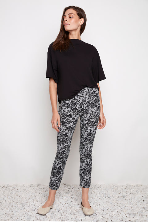 Model wearing UP! Lacey Techno Petal-Slit Ankle Pant in Black & White Lacey print, front view.