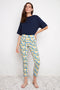 Model wearing UP! Lemon Blossom Techno Petal-Slit Ankle Pant featuring a slim fit and petal vent hem.