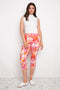 Model wearing UP! Sunset Techno Vented Capri Pant in Sunset print, front view.