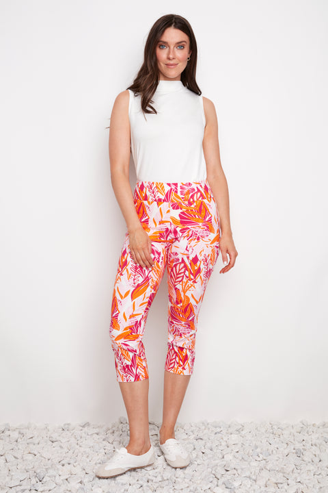 Model wearing UP! Sunset Techno Vented Capri Pant in Sunset print, front view.
