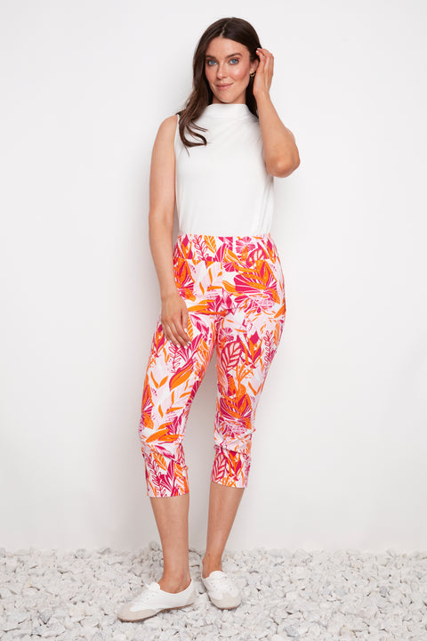 Model wearing UP! Sunset Techno Vented Capri Pant in Sunset print, front view.