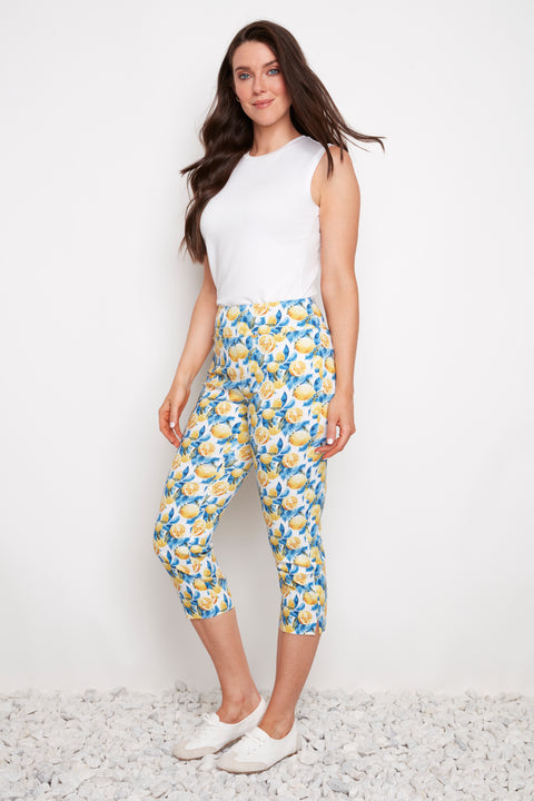 Side view of model wearing UP! Lemon Blossom Techno Vented Capri Pant in Lemon Blossom print with side vent detail.