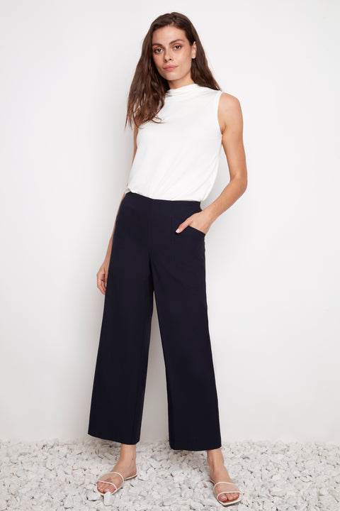 Model wearing UP! Techno Core Wide Leg Pant in Navy, front view.