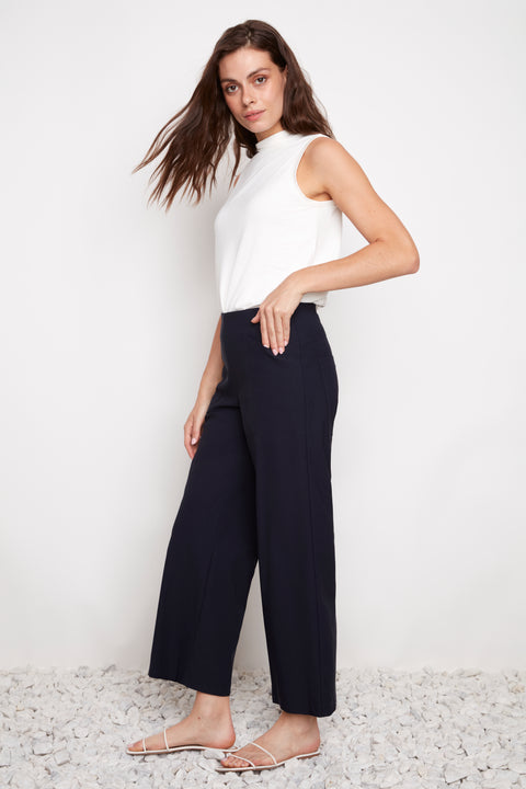 Side view of model wearing UP! Techno Core Wide Leg Pant in Navy with cargo-style pocket detail