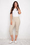 Model wearing UP! Techno Core Capri Pant in Sand, front view.
