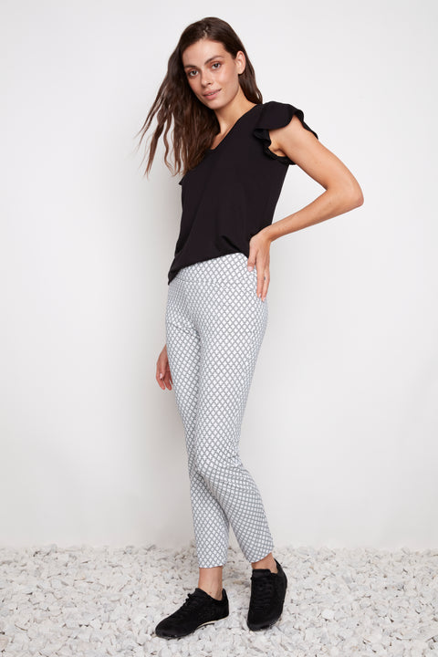 Side view of model wearing UP! Casa Soft Stream Ankle Pant in Casa print with side vent detail.