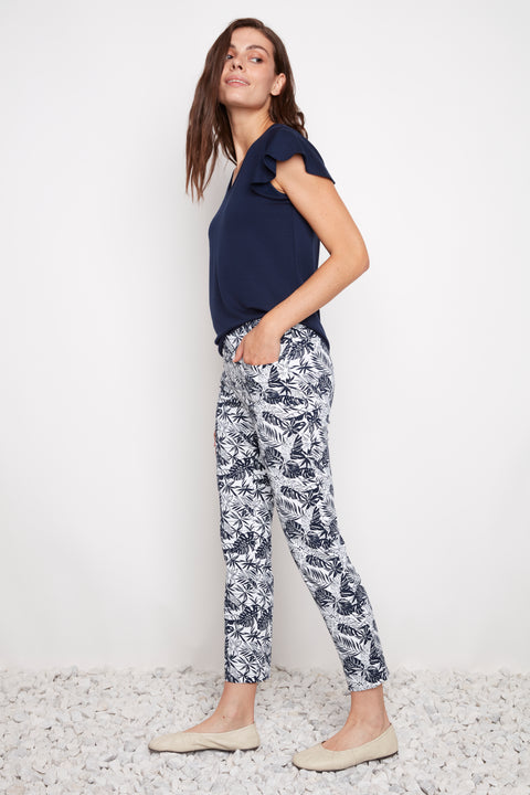 Side view of model wearing UP! Cabo Soft Stream Ankle Pant in Navy Cabo print with side vent detail.