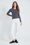Woman wearing the Precision Ponte Slim Pant in White with Animal Print interior lining.