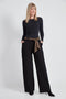 Woman wearing the Ponte Tie-Sash Wide Leg Pant in Black.