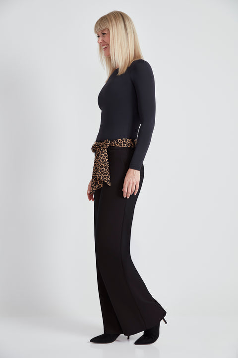 Woman wearing the Ponte Tie-Sash Wide Leg Pant in Black, side view.