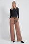 Woman wearing the Ponte Tie-Sash Wide Leg Pant in Biscuit.