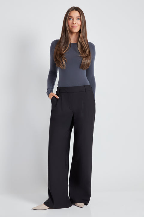 Woman wearing the Precision Ponte Wide Leg Pant in Black.
