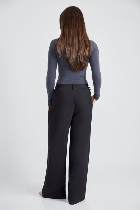 Woman wearing the Precision Ponte Wide Leg Pant in Black, back view.