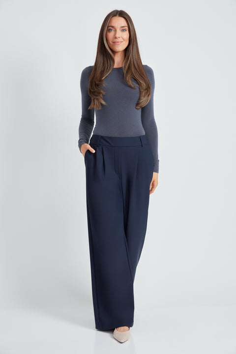 Woman wearing the Precision Ponte Wide Leg Pant in Navy.