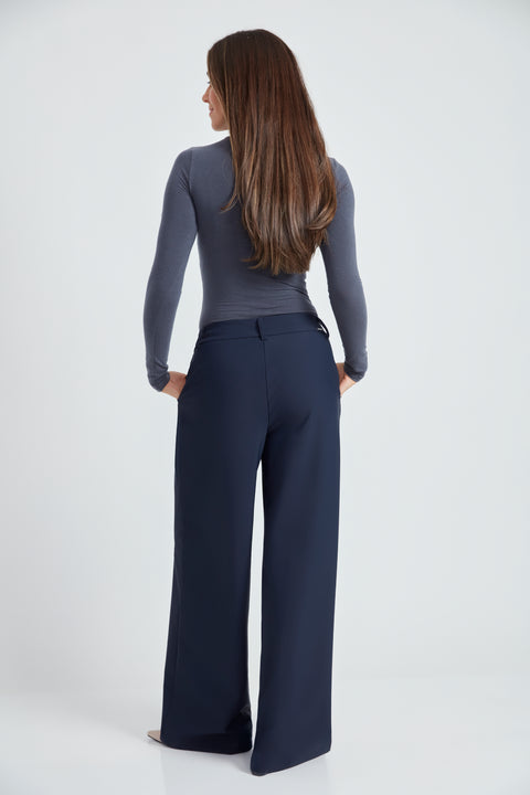 Woman wearing the Precision Ponte Wide Leg Pant in Navy, back view.