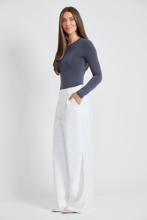 Woman wearing the Precision Ponte Wide Leg Pant in White, side view.