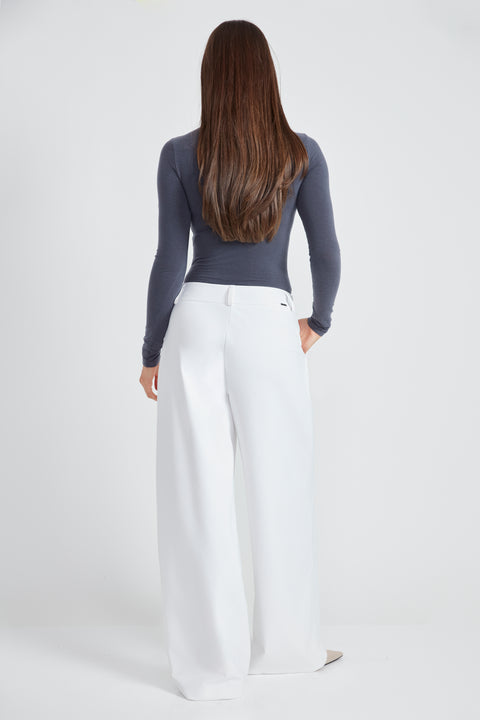 Woman wearing the Precision Ponte Wide Leg Pant in White, back view.